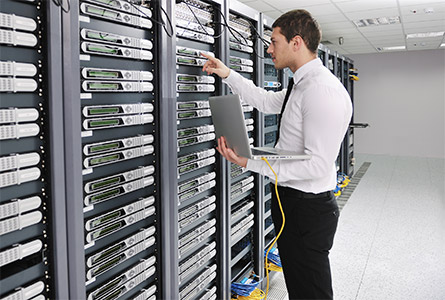 man working on a network rack