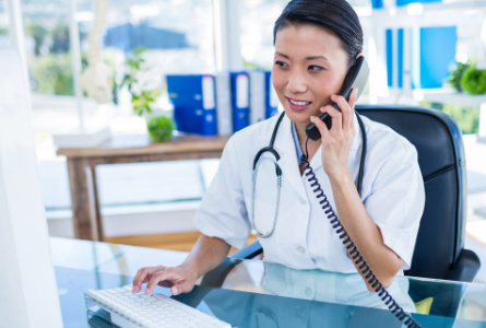 woman at desk talking on phone