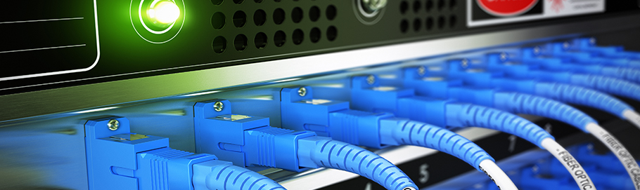 Multiple fiber optic cables plugged into an enterprise router