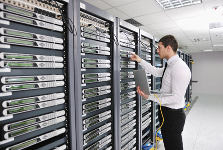 man working on a network rack