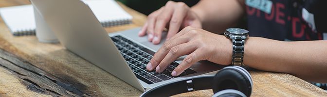 A person typing on a laptop.