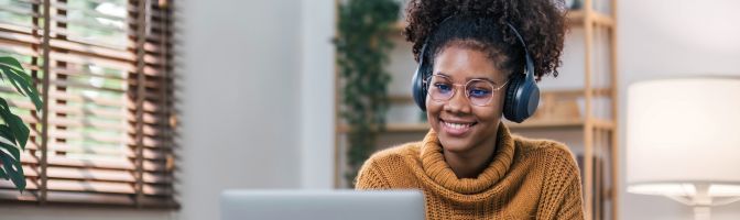 woman smiling at camera on computer working from home