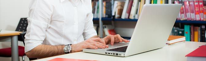 Person using laptop in library