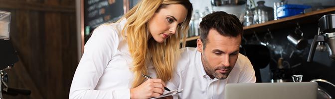 Man and woman looking at laptop