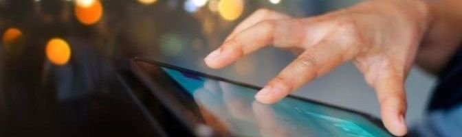Closeup of a hand scrolling through a digital tablet