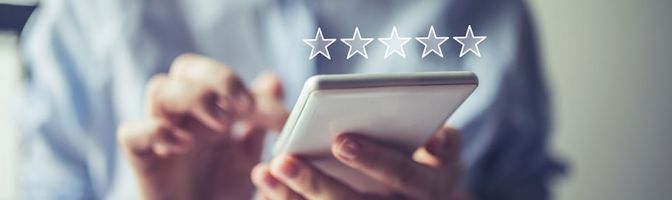 close up of person using phone with a star rating superimposed