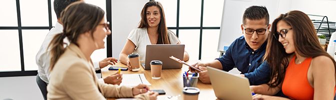 A group of business professionals brainstorming marketing ideas at a conference table.