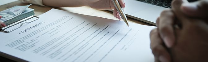 Two business professionals going over an agreement document.