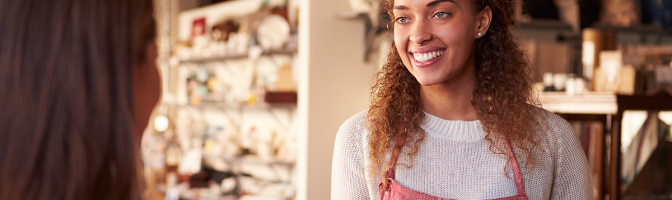 Sales Assistant With Credit Card Reader On Digital Tablet