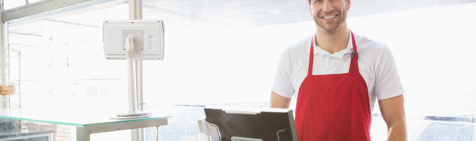 Casual server posing behind the counter at the bakery