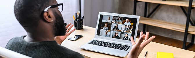 An entrepreneur gives a virtual talk to a group of small business owner through a video conference.