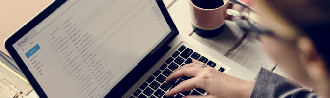 Businesswoman Checking E-mail Online on Laptop