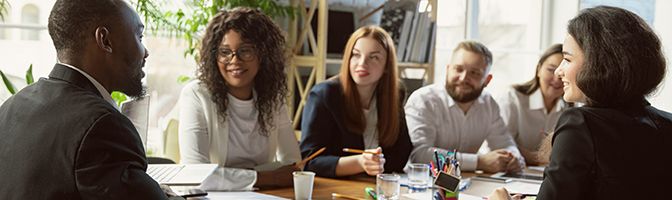 A group of staff members having a discussion during a meeting.