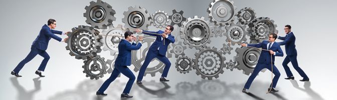 business people tug-of-war with gears and cogs