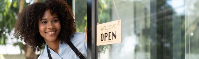 friendly business owner opening shop