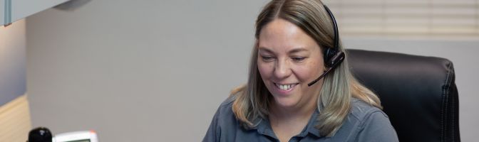 smiling female customer service rep with headset on