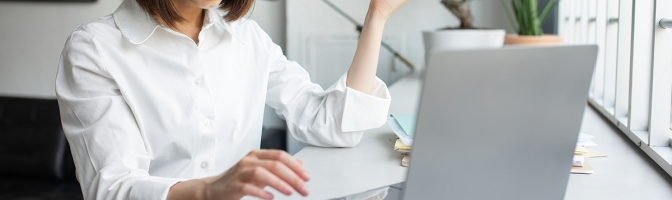 Shocked businesswoman looking at laptop with disbelief, working in coworking space, office.