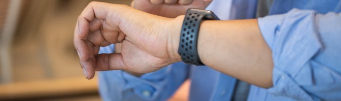 man checking smart watch with blue dress shirt on