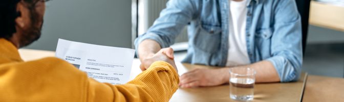 two men shake hands at casual office