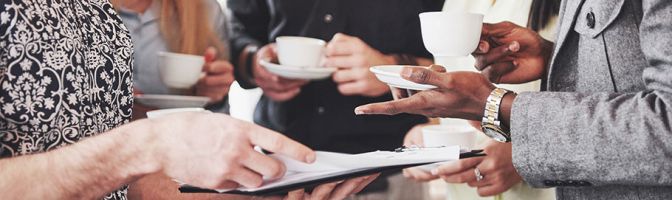 people discussing work while having coffee