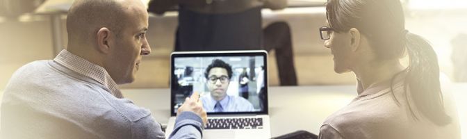 two people having a video conference call on a laptop