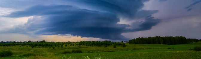 storm clouds rolling in over field 