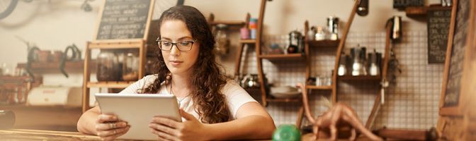 woman looking at tablet in store