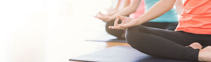 close up of women doing yoga