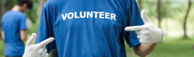 Close up young man volunteering wearing t-shirt with volunteer message