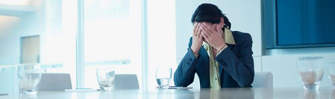 exhausted woman alone in conference room