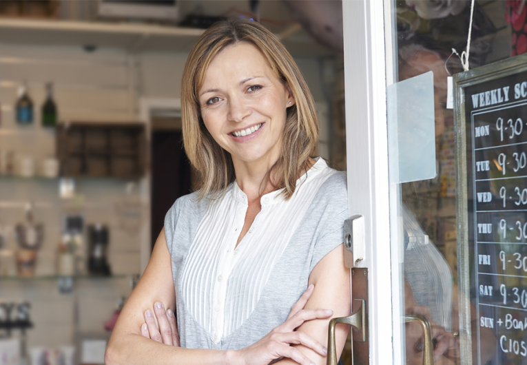 Owner Of Gift Shop Standing In Doorway