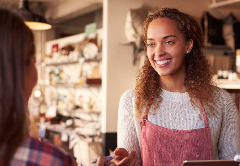 Sales Assistant With Credit Card Reader On Digital Tablet