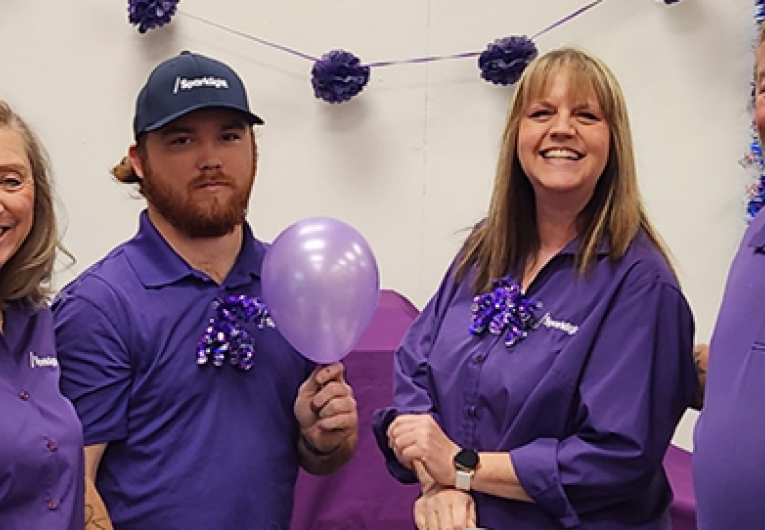 Sparklight employees gathered inside of Borger, TX Sparklight office storefront