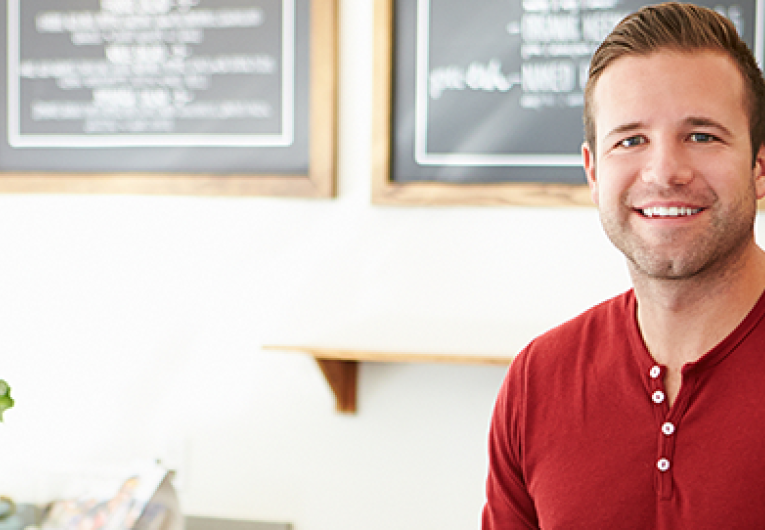 coffee shop worker or owner standing at digital cash register