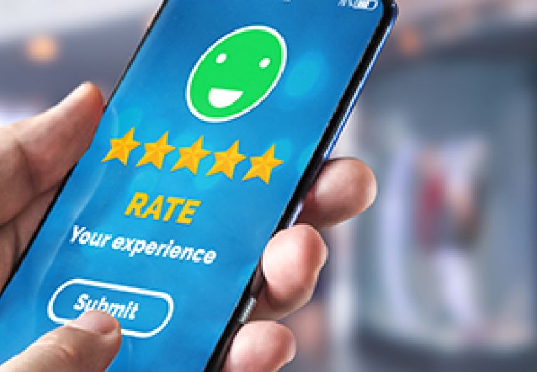 A close up of a smartphone screen showing a customer providing a satisfaction rating.