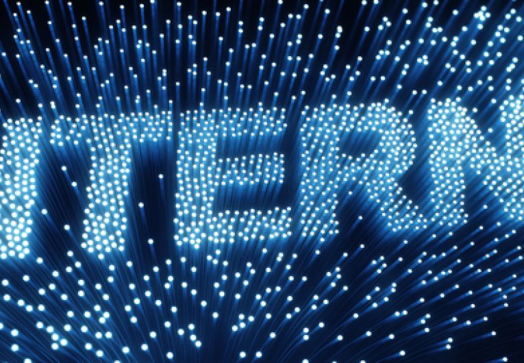 The word internet spelled out in fiber optic cable lights