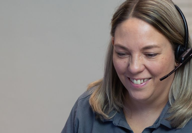 smiling female customer service rep with headset on