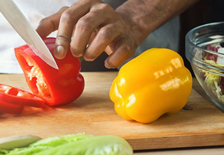person slicing bell peppers