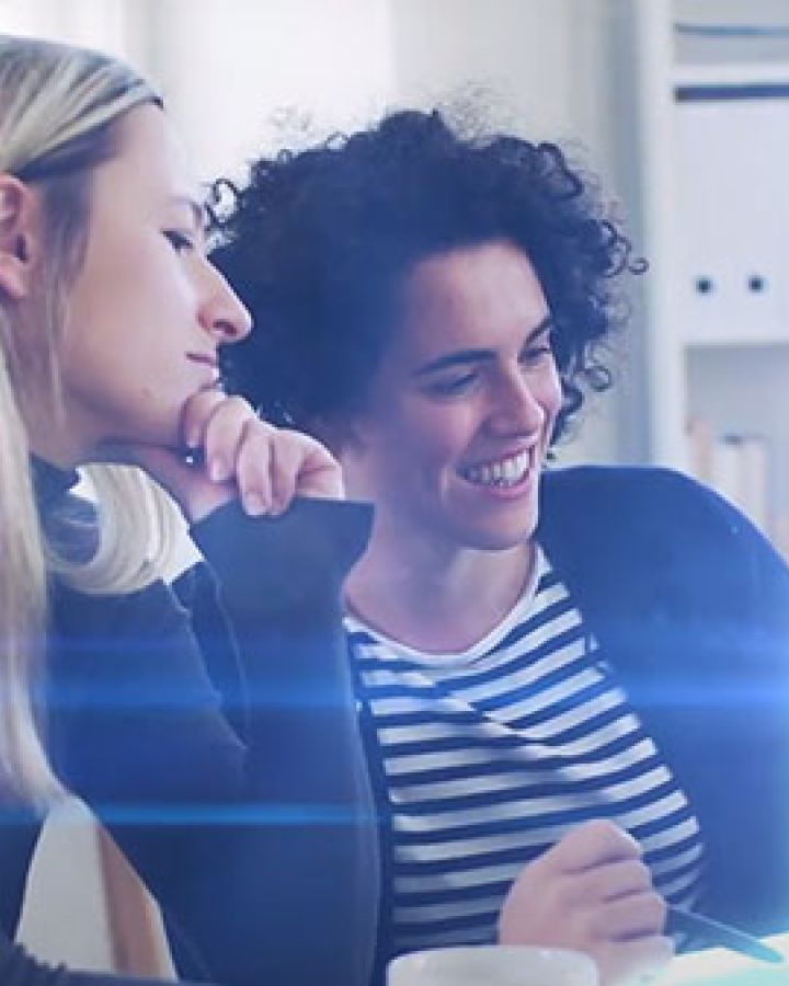 Two women viewing desktop screen