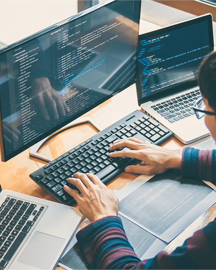 male programmer working on computer 