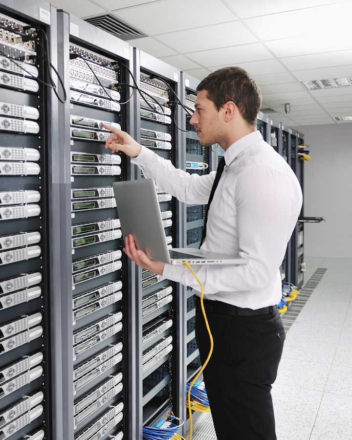 Tech checking server settings in large server room
