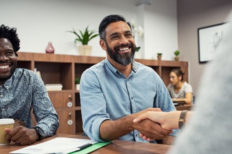 Two Channel Agent people shaking hands in an office setting