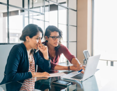 two women looking at laptop