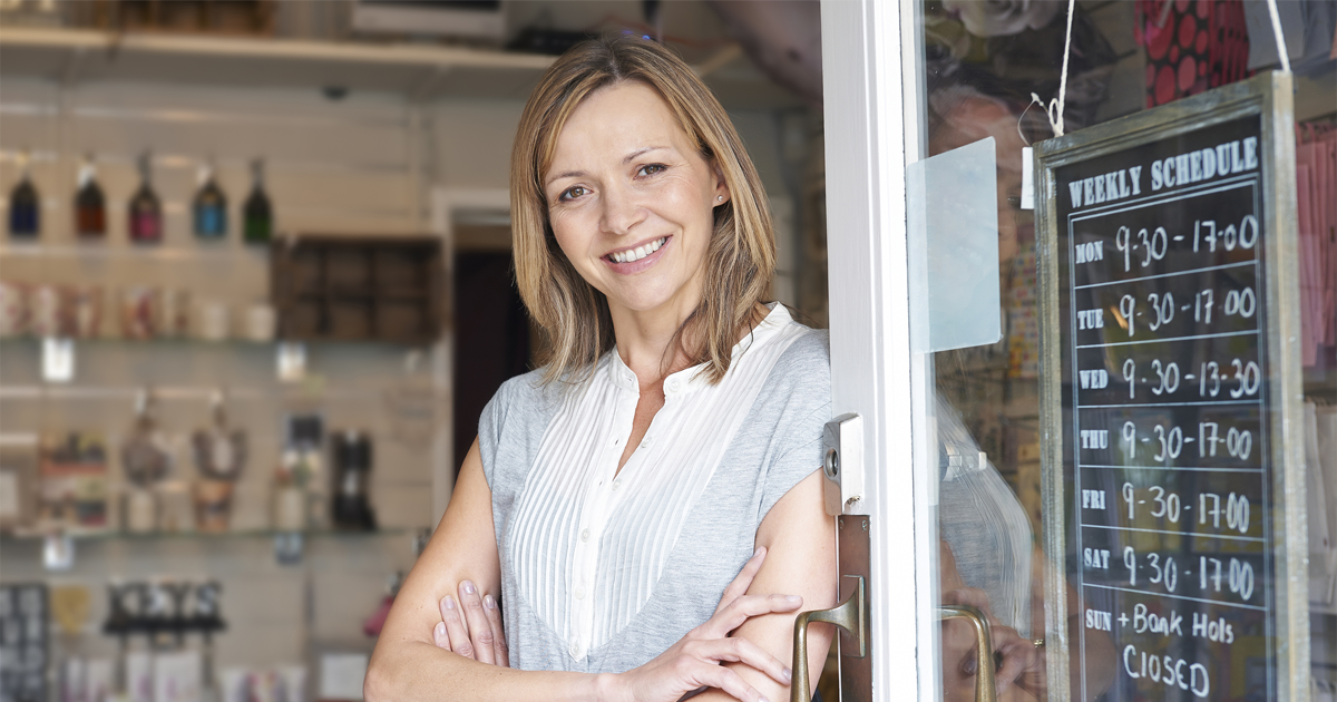 Owner Of Gift Shop Standing In Doorway