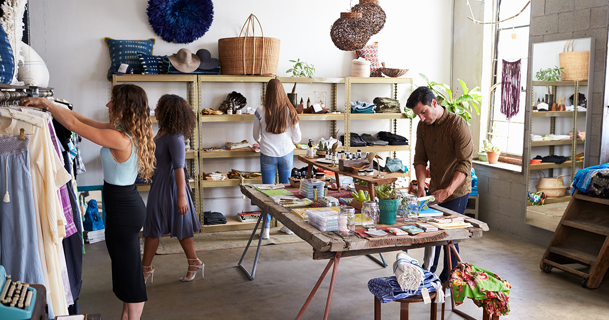 Customers and staff in a busy clothes shop