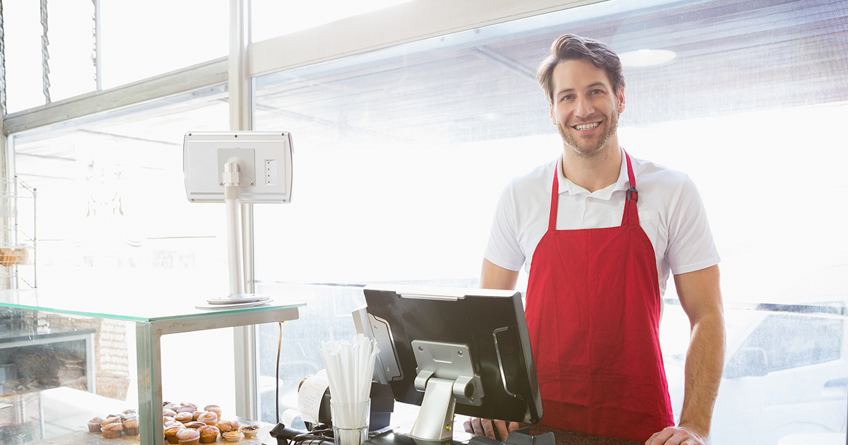 Casual server posing behind the counter at the bakery