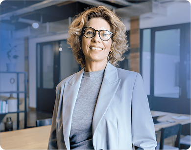 Professional woman wearing glasses and a gray suit